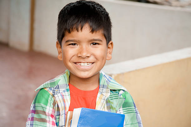 istock Cute little boy excited for school. He holds textbooks. 483105680