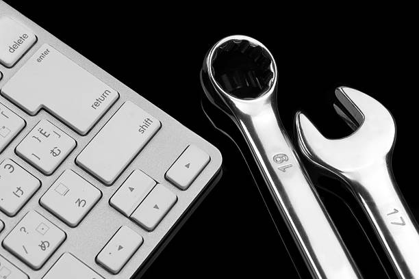 istock Chrome Plated Wrenches And Wireless Keyboard Isolated On Black 483106096
