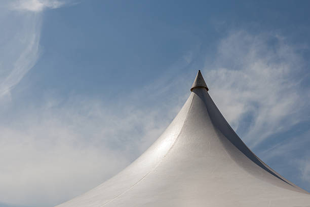 istock Top of white canvas tent under blue sky background 483106196