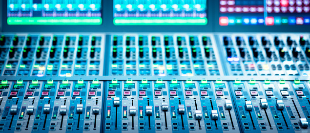 Close-up shot of a audio mixing board.
