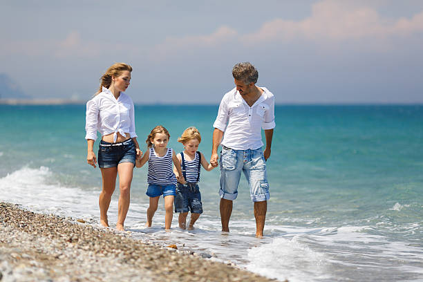 istock Family with two kids on the beach 483111192