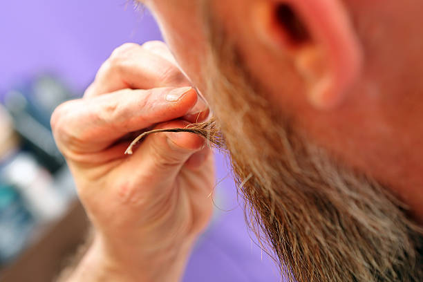 istock Barber modeling beard and mustache shapes in hair salon 483113614