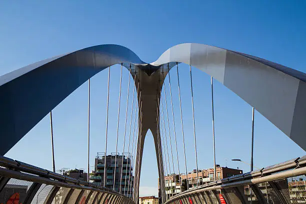 new modern footbridge with supporting arches and steel bulkheads