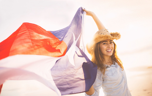 Smiling Woman with Texas state flag waving in the wind