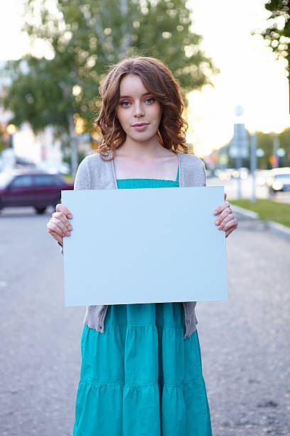 istock Young woman with blank banner. 483118265