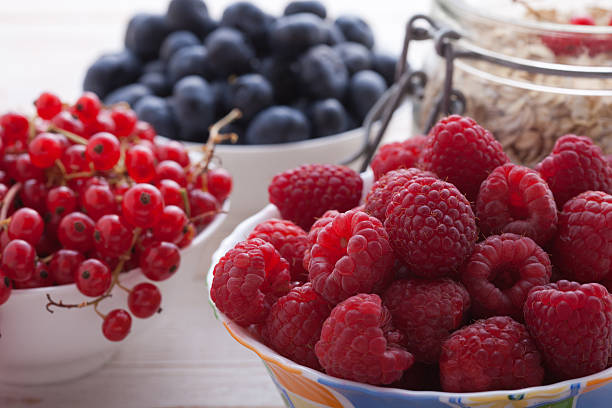 istock Breakfast - berries, fruit and muesli on white wooden 483118474