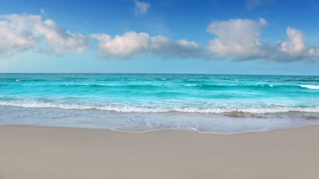 Aqua perfect white sand beach with waves and clouds