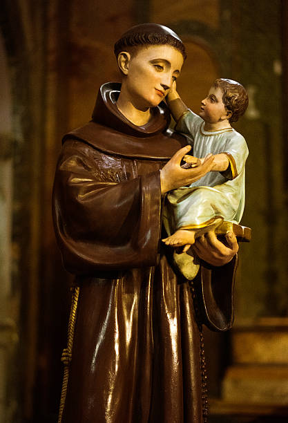 polychrome statue of monk and baby polychrome statue of monk and baby on a small roman church, italy st anthony of padua stock pictures, royalty-free photos & images