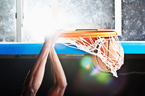 A black basketball player, doing a dunking. XXL size image. Image taken with Canon EOS 1 Ds Mark II and EF 70-200 mm USM L.