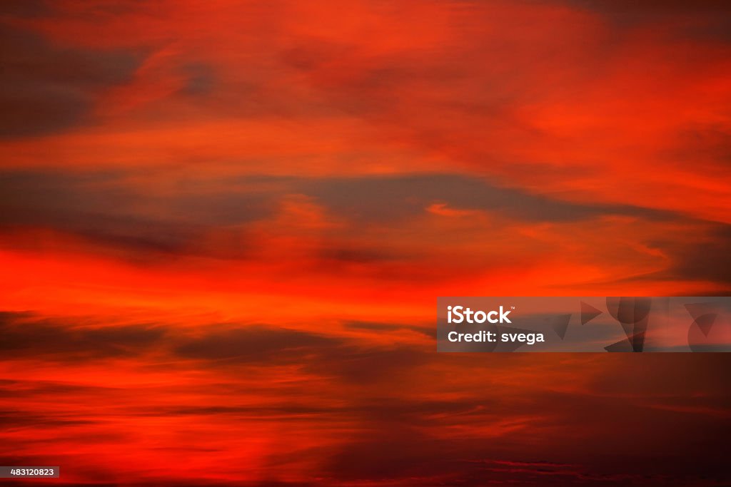 Red, dramatic sunset This is image of beautiful sunset. Sky is red and dramatic.  Backgrounds Stock Photo