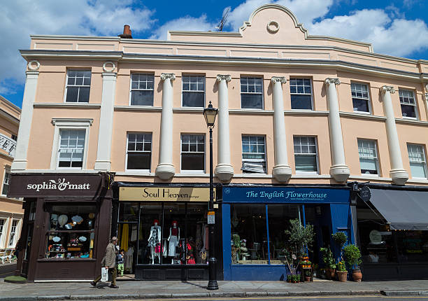 London, UK - July 21, 2015: Buildings and shops along Greenwich Church Street in London. People can be seen.