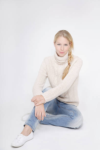 istock Young woman wearing tutleneck jumper sitting 483123840