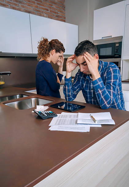 istock Desperate young couple with debts reviewing their bills 483124376