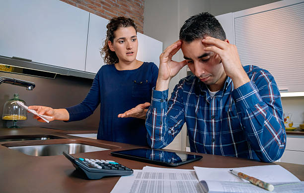istock Desperate young couple with debts reviewing their bills 483124388