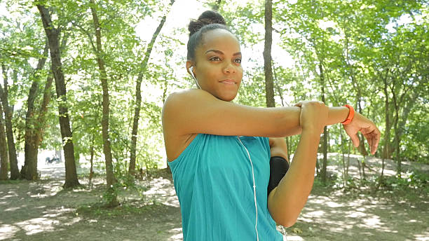 istock Woman stretching arms before running off road during workout 483124450