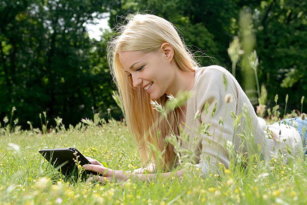 istock Young woman with tablet in park 483124582