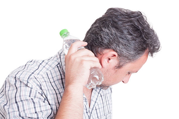 istock Man cooling down with a bottle of cold water 483127598