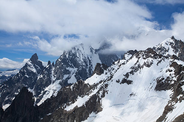 Clouded Mont Blanc peak and Aiguille Noire de Peuteurey stock photo