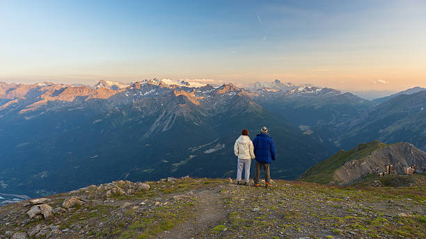 istock Couple watching panorama high up in the Alps 483130610