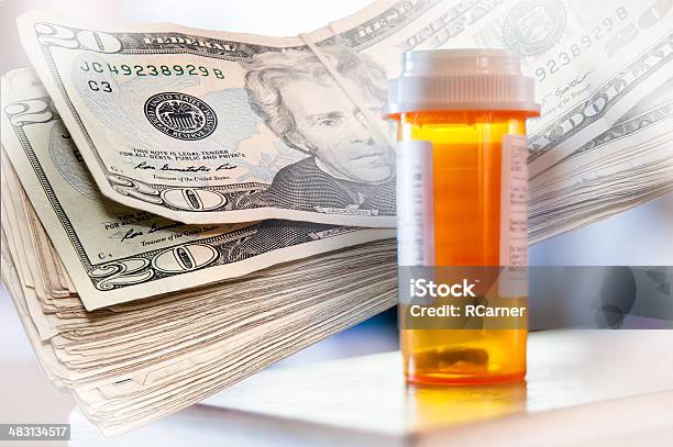 Medicine Bottles And Money Stock Photo - Download Image Now - Bottle, Capsule - Medicine, Care