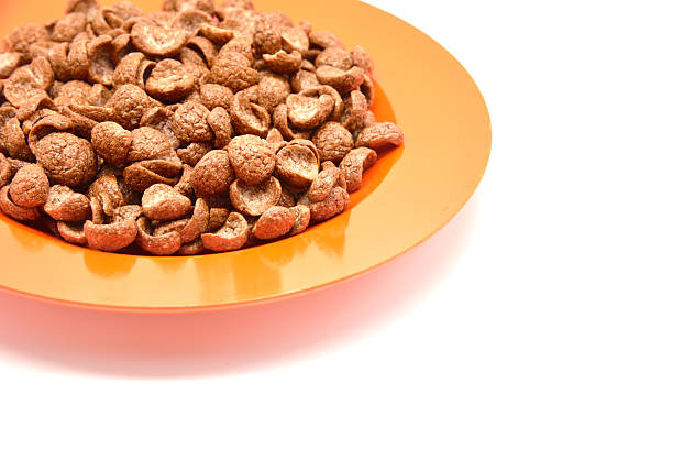 Isolated cereal on orange dish Isolated cereal on orange dish cerial stock pictures, royalty-free photos & images