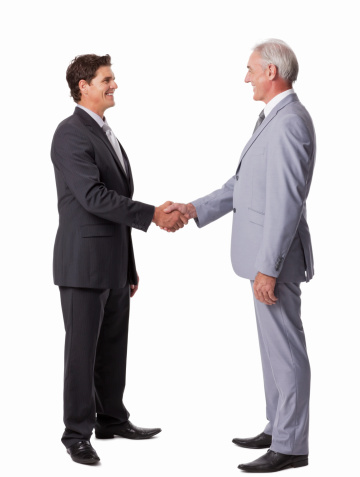 Full length of happy business colleagues greeting each other. Vertical shot. Isolated on white.