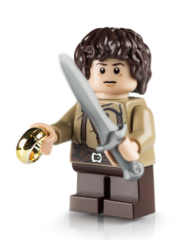 Virginia, USA - June 10, 2013: Close up of the Lego mini-figure Frodo from the Lord of the Rings complete with gold ring and sword. Lego is a famous toy produced by the Danish company Lego Group. Mini-figures were first produced in 1978. The modern Lego brick was patented in 1958