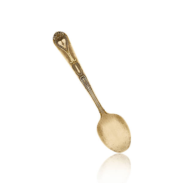 istock old brass spoon isolated on white background 483137403