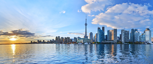 Aerial view of waterfront of Downtown Toronto with CN Tower rising into sunny sky, Canada.