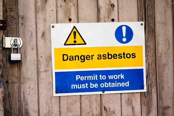 Danger asbestos - sign outside a derelict building stock photo