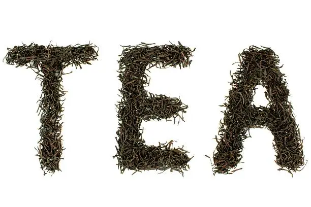 Black tea, tea text written with tealeaves