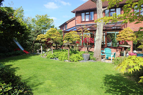 istock Image of modern red-brick house and back garden lawn / conservatory 483140634