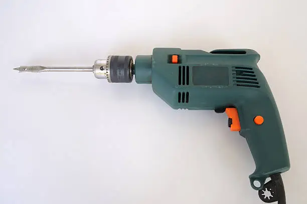 Electric drill connected with drill-bit.