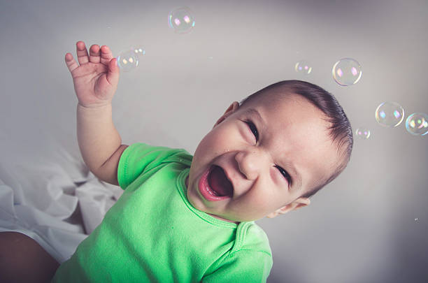 istock cute baby boy playing and having fun with bubbles smiling 483141554