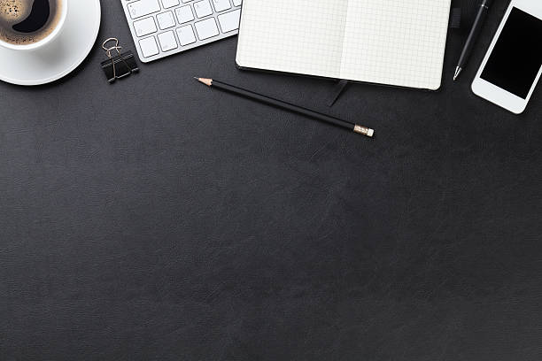 istock Office leather desk with computer, supplies and coffee 483145196