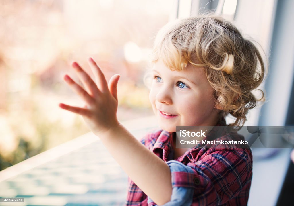 Happy Cute girl sitting alone near window 2015 Stock Photo