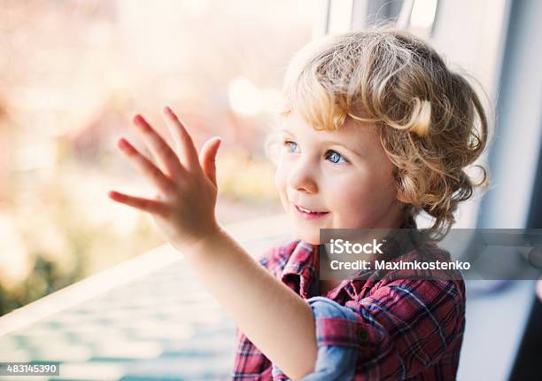 Happy Cute Girl Sitting Alone Near Window Stock Photo - Download Image Now - 2015, Beautiful People, Beauty