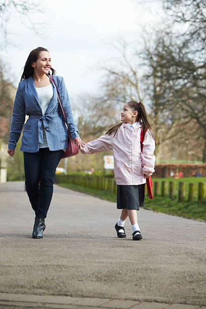 istock Mother Walking Daughter To School Along Path 483145416