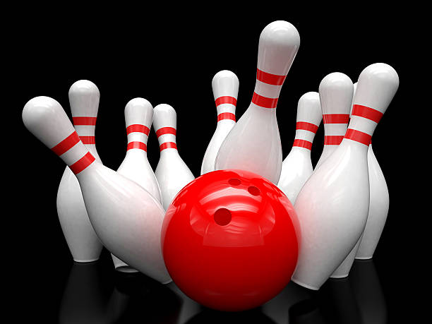 istock Bowling ball and scattered skittles 483146262