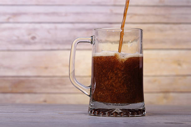 istock pour into a glass of dark beer 483147047