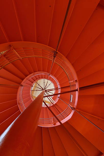 istock Orange round staircase in modern office building 483147165
