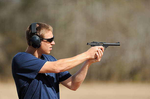 istock Teenager boy shooting pistol handgun 483147731
