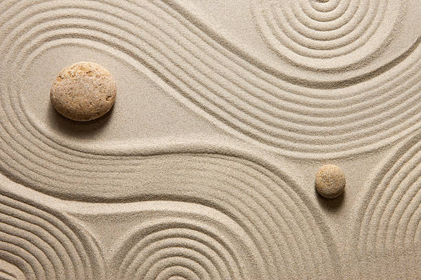 Zen garden Top view of raked sand with stones pebble shapes stock pictures, royalty-free photos & images