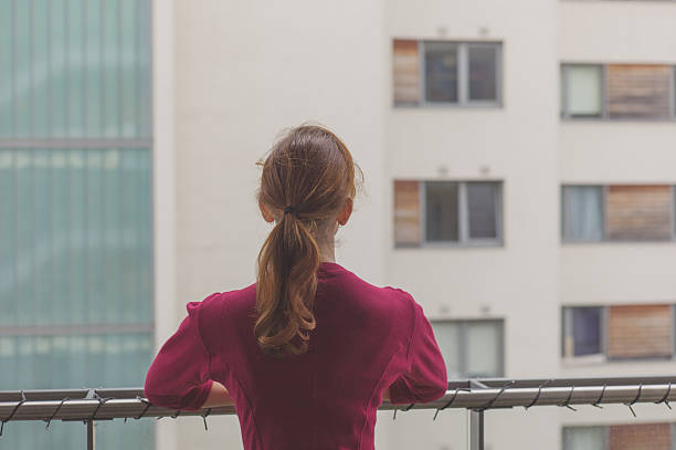 istock Woman standing on balcony of apartment 483147972