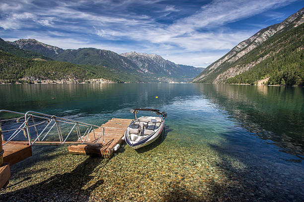 beautiful scenery on a calm morning at Anderson lake,  north of whistler, british columbia, canada on the labor day long weekend. preparing to go have fun boating and wakesurfing all day with friends.