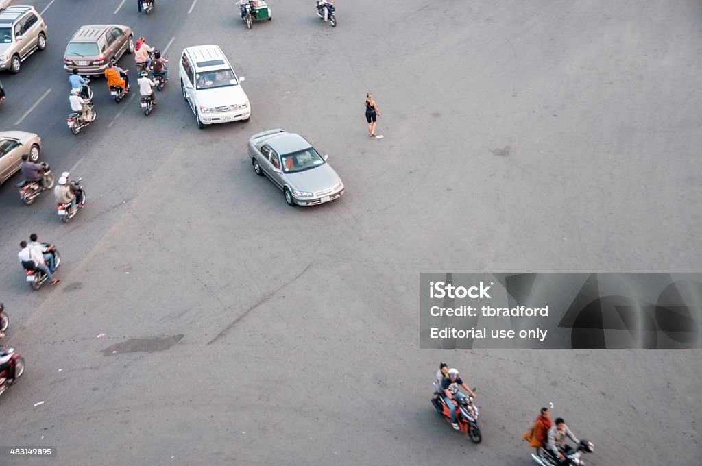 Traffic At A Road Junction Phnom Penh, Сambodia - December 11, 2013: Motorists, cars and pedestrians at a busy road junction in the Cambodian capital city of Phnom Penh Asia Stock Photo