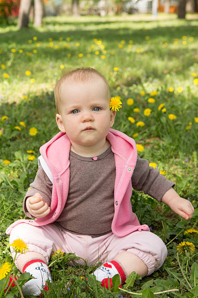 istock Little baby playing in the park on the grass 483150049