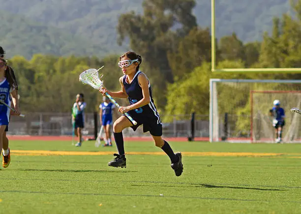 Photo of Girl Playing Lacrosse Mid Air