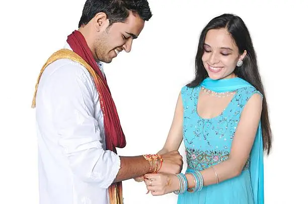Sister tying Rakhi on her brother's wrist on the occasion of Rakshabandhan in India.