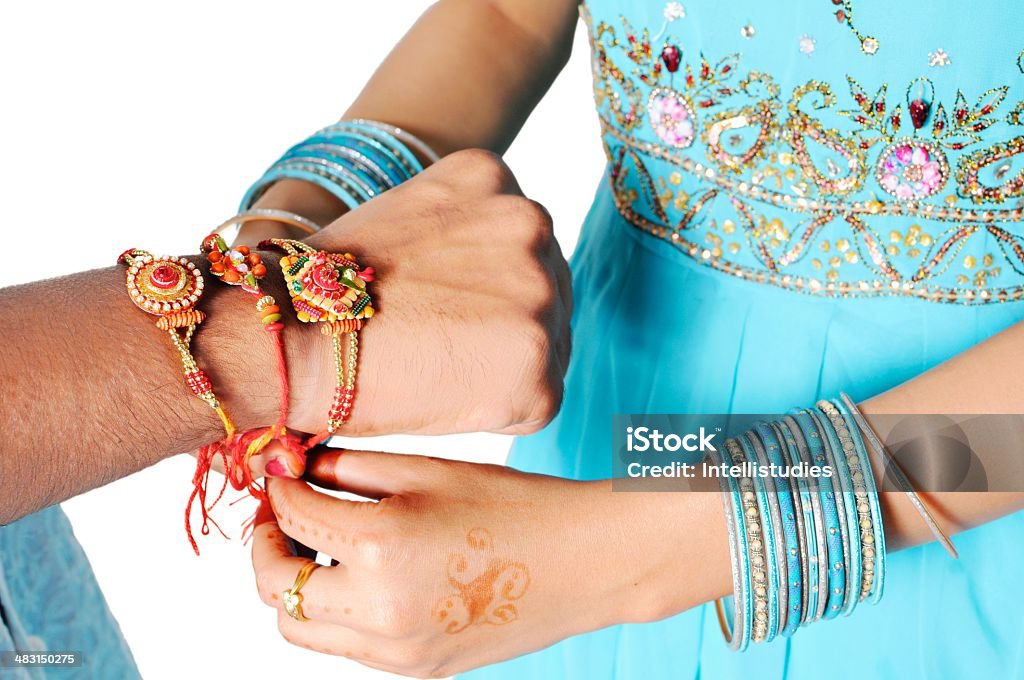 Closeup of hands tying rakhi over brother's wrist. Rakshabandhan, celebrated in India as a festival denoting brother-sister love and relationship. Sister tie Rakhi as symbol of intense love for her brother Raksha Bandhan Stock Photo